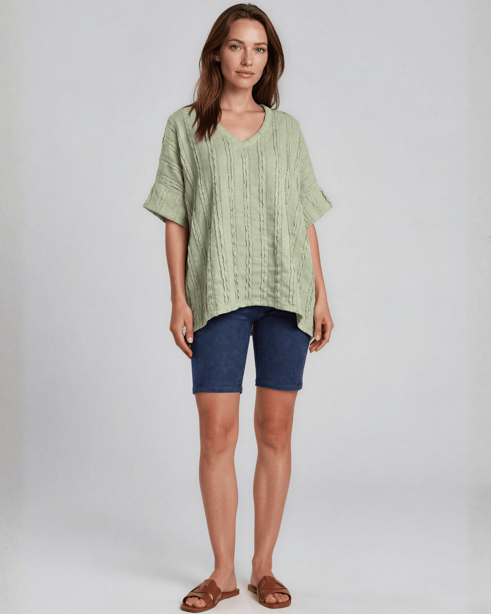 Shop the Laurel Textured Top in Light Sage — a relaxed oversized v-neck with striped lace effect, contrast sleeve bands & side slit. Made in USA.