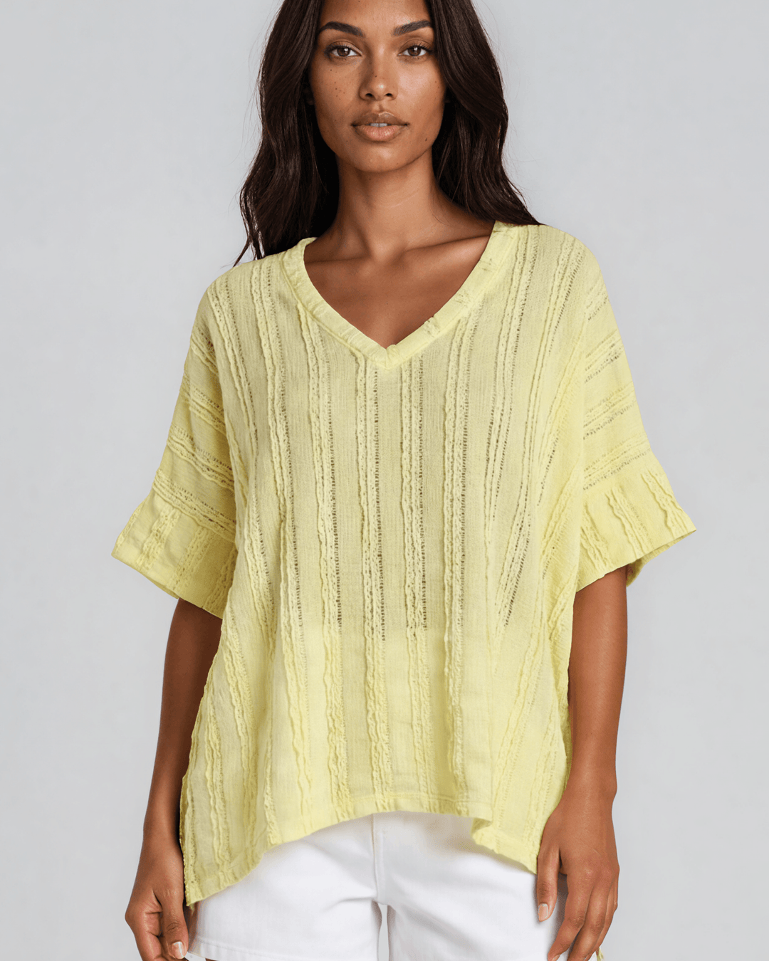Shop the Laurel Textured Top in Yellow — a relaxed oversized v-neck with striped lace effect, contrast sleeve bands & side slit. Made in USA.