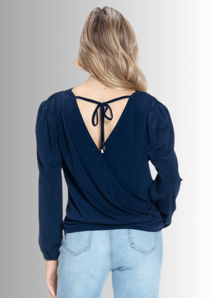 Elevate your wardrobe with the Maxine Surplice Tie Back Top in navy. Crafted in the USA from stretchy jersey fabric, this waist-length, long-sleeve, both comfort and style