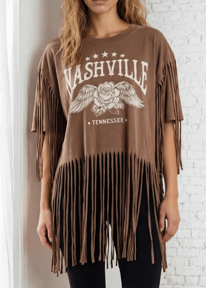 The Farrah Fringe Nashville Top brings effortless style to your everyday wardrobe. Featuring playful fringe detailing and a relaxed silhouette, this versatile piece pairs beautifully with jeans, leggings, or your favorite bottoms. The soft cotton-blend fabric with a touch of spandex offers comfort and gentle stretch, while the round neckline and short sleeves keep things casual and chic. Perfect for layering or wearing solo, this made-in-USA top is a wardrobe essential that works from season to season. 