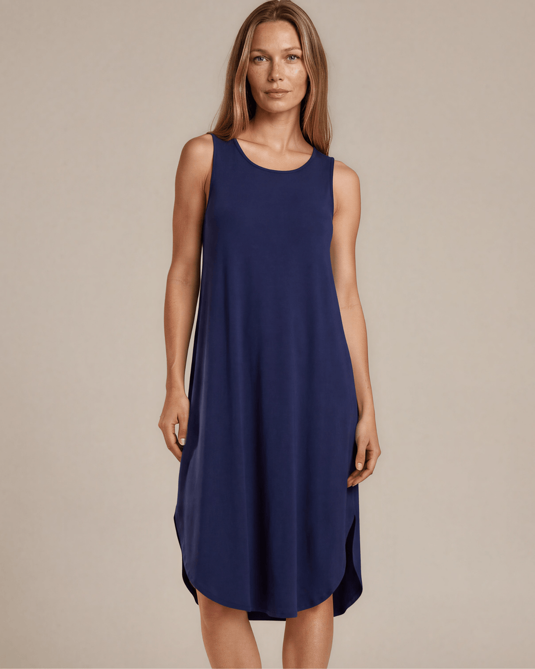 Sammie Sleeveless Midi Dress in navy blue. Relaxed fit, scoop neck, side pockets & slits. 95% Rayon, 5% Spandex. Made in USA.