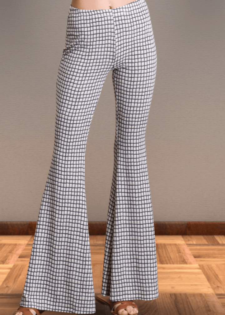 Step up your style game with these Jersey Plaid Skinny Flares, designed to flatter every curve with their mid-rise, slim-fit cut that elegantly flares at the ankle. Made from a luxuriously soft jersey fabric blend, they offer unbeatable comfort and stretch for all-day wear. The timeless black and off-white plaid pattern adds a bold yet classic touch, making these pants perfect for turning heads whether at the office or out on the town. Bucket List Style P5009D