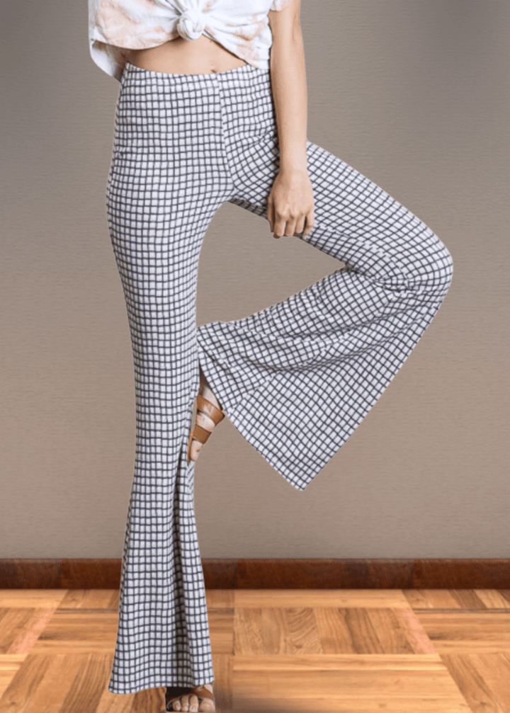 Step up your style game with these Jersey Plaid Skinny Flares, designed to flatter every curve with their mid-rise, slim-fit cut that elegantly flares at the ankle. Made from a luxuriously soft jersey fabric blend, they offer unbeatable comfort and stretch for all-day wear. The timeless black and off-white plaid pattern adds a bold yet classic touch, making these pants perfect for turning heads whether at the office or out on the town. Bucket List Style P5009D