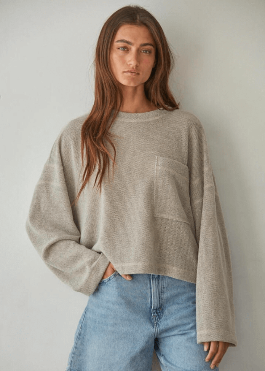 Embrace cozy elegance with this American made Perfect Fall Sweater in Taupe. Featuring a soft knit Hacci fabric and a flattering round neck, its medium length and loose fit offer comfort without sacrificing style.