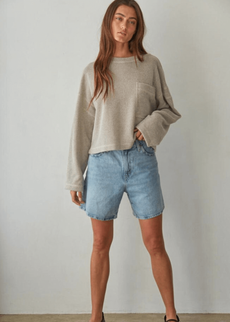 Embrace cozy elegance with this American made Perfect Fall Sweater in Taupe. Featuring a soft knit Hacci fabric and a flattering round neck, its medium length and loose fit offer comfort without sacrificing style.