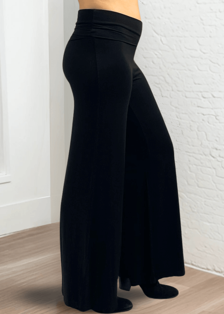 Experience ultimate comfort and style with these Soft Rayon Jersey Palazzo Pants in Solid Black, crafted in the USA. Featuring a flattering fold-over waist and a wide-leg silhouette, they offer a relaxed yet chic look. Made from a stretchy blend of rayon and spandex, these pants move with you while maintaining their softness.