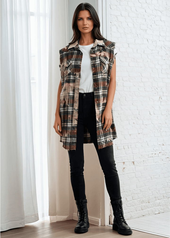 Meet The Sedona Sunset Sleeveless Plaid Flannel Tunic - a sleeveless, boho-chic essential designed for effortless layering and laid-back luxury. Crafted in Los Angeles from ultra-soft, vintage-washed plaid, this one-of-a-kind piece features hand-bleached details, raw frayed edges, and classic chest pockets for a relaxed yet elevated vibe. Its tunic length makes it versatile enough to wear open over denim shorts or buttoned up as a dress.