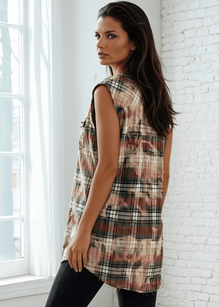 Meet The Sedona Sunset Sleeveless Plaid Flannel Tunic - a sleeveless, boho-chic essential designed for effortless layering and laid-back luxury. Crafted in Los Angeles from ultra-soft, vintage-washed plaid, this one-of-a-kind piece features hand-bleached details, raw frayed edges, and classic chest pockets for a relaxed yet elevated vibe. Its tunic length makes it versatile enough to wear open over denim shorts or buttoned up as a dress.