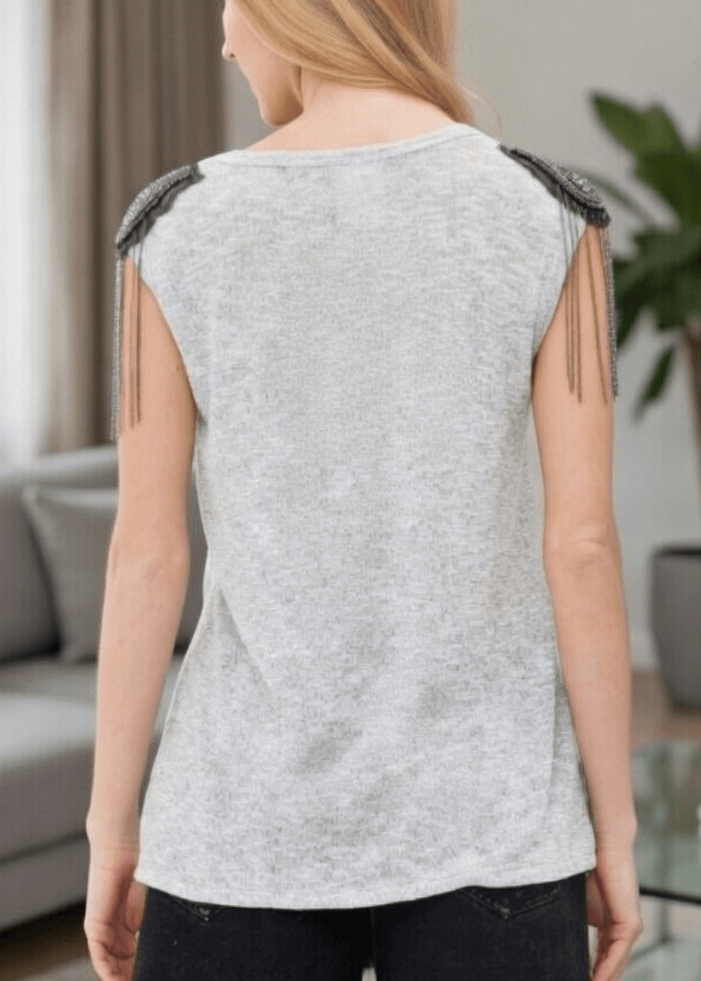 Make a bold statement with this standout made in USA sleeveless top, designed to turn heads with its sparkling star-embellished beads and shoulder fringe. The heathered gray loose knit fabric drapes beautifully while the built-in stretch ensures all-day comfort and ease of movement. 